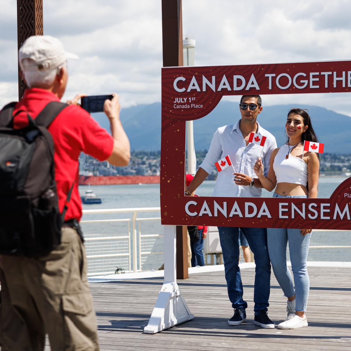 People taking photos behind a frame